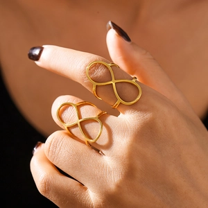 Gold PVD plated stainless steel figure-eight open ring shown on model fingers