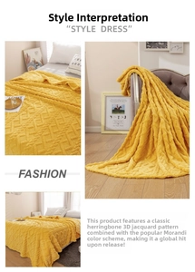 Detail of yellow 3D jacquard flannel blanket featuring textured diamond cable knit patterns