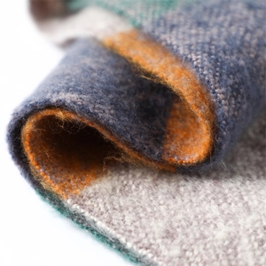 Close-up of soft cashmere-like scarf showing colorful block weave and fuzzy texture