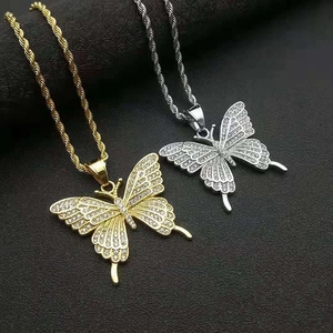 Close-up of butterfly pendants with sparkling rhinestones in gold and silver finish