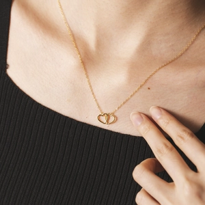 Elegant S925 silver heart necklace in gold worn by a model to show dainty collarbone style
