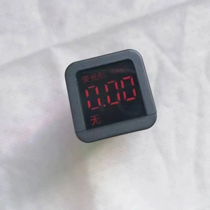 Fluorescence detector showing zero value on a white cloth background for cotton towels