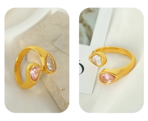 Detailed macro view of 18k gold-plated open ring with pink and white teardrop zircons
