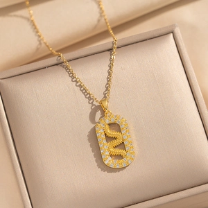 Elegant gold plated snake pendant necklace with white zircon on a luxury jewelry box