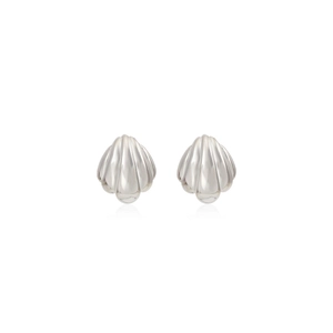 Detailed macro view of silver scallop-shaped stud earrings with high-polished metal finish