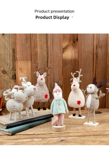 Detail of wool felt reindeer and gnome figurines on wooden bases for Christmas decor