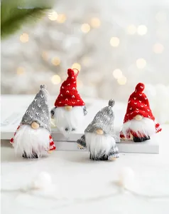 Set of four handmade Christmas gnomes with knitted hats and white beards on a cozy background
