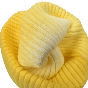 Close-up of bright yellow knit beanie with thick ribbed texture and warm winter cuff