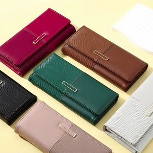 Detail of multi-color paneled long wallets for women with metal clasp and striped texture