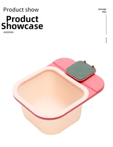 Detail of wall-mounted pink plastic storage box with rear hanging hook for kitchen use