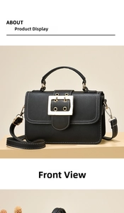 Detail view of black PU leather bag with white stitching and large gold square buckle