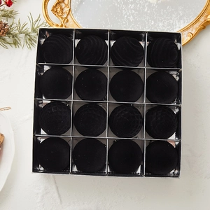 Set of 16 black flocked Christmas balls with assorted textures in a silver display box