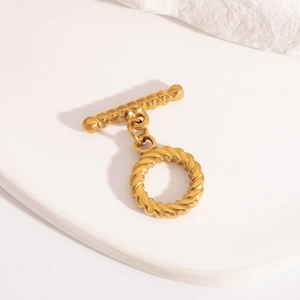 Detailed macro view of a gold rope-textured toggle clasp for jewelry making