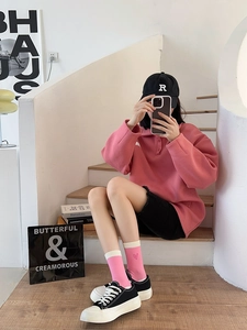 Pink heart embroidery crew socks styled with pink polo shirt and casual black shorts