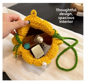 Detail view of the spacious inner storage of yellow floral knit crossbody bag with cosmetics