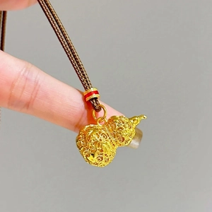 24k gold-plated Wu Lou pendant necklace with intricate hollow carving on a brown cord