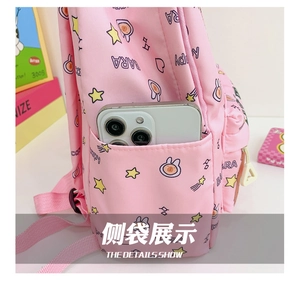 Pink kids backpack side pocket detail showing storage capacity with a smartphone