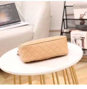 Detailed side view of beige quilted leather handbag with premium caviar texture