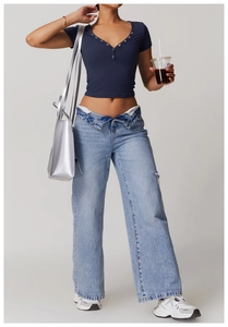 Detail of navy blue V-neck fitness tee with metal eyelets and wide-leg jeans