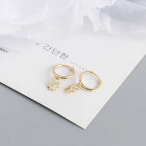 Macro shot of gold S925 sterling silver octagonal hoop earrings with star diamond charms
