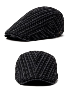 Detail view of cotton newsboy cap showing white pinstripes and adjustable metal buckle
