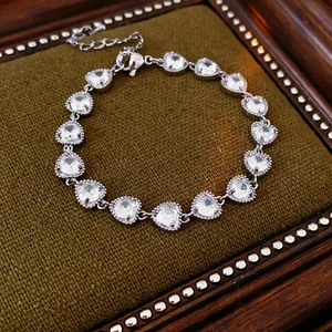 Detail of heart-cut zircon bracelet with silver metal bezel and adjustable lobster clasp