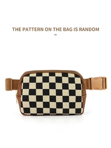 Macro detail of checkerboard crossbody bag with brown trim and golden zipper