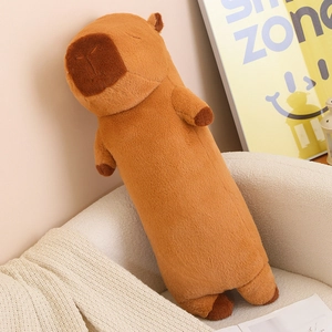 Close-up of a long capybara plush pillow on a white sofa in a cozy interior setting