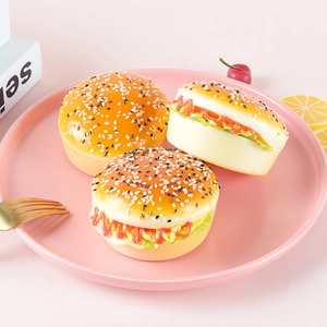 Set of three realistic PU faux hamburger models with sesame seeds on a pink plate