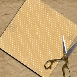 Close-up of vintage yellow polka dot scrapbook paper with retro newspaper text collage