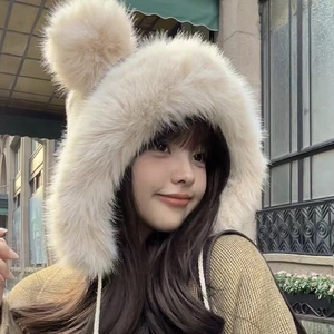 Detail of plush beige earflap hat with cute bear ears and soft faux fur texture