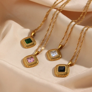 Detailed view of four vintage gold rhombic necklaces with colorful zircon stones on silk