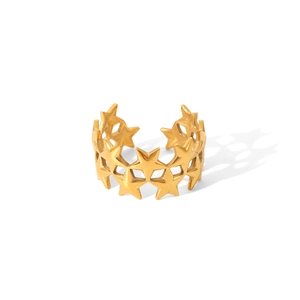 Detailed close-up of a 18K gold star shaped open ring with polished metal finish