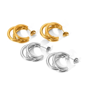 Close-up of triple hoop earrings in gold and silver finish showing layered design details