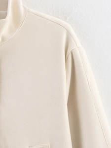Detailed close-up of cream suede jacket collar showing soft brushed texture and stitching