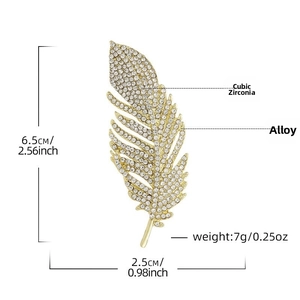 Detailed view of feather brooch with gold alloy base and micro-set rhinestones
