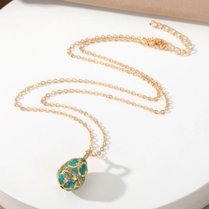 Vintage Faberge style teal enamel egg pendant necklace with gold patterns and crystals