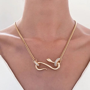 Gold snake pendant necklace with shimmering crystals and a stylish Cuban chain link