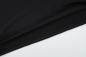 Detailed close-up showing the premium double-needle stitching on the black knitted cotton hem