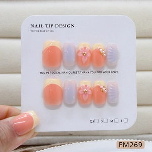 Handmade press-on nails with 3D floral and pearl accents on elegant pink glossy finish