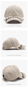 Three-angle view of beige distressed baseball cap with Urban World gothic embroidery