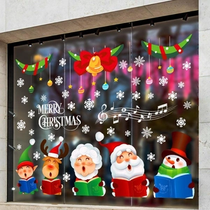 Détail de stickers de Noël avec Père Noël et bonhomme de neige sur fond de verre vitré