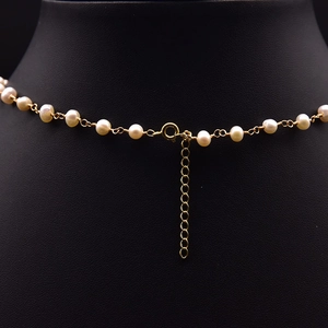 Elegant natural freshwater pearl necklace with gold clasp on black jewelry display stand