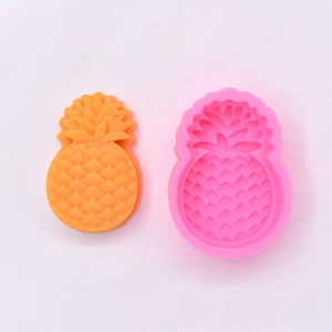 Detailed macro view of pineapple silicone mold and bright orange 3D resin craft