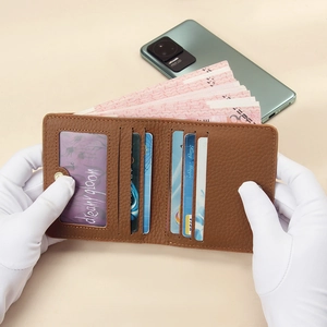 Brown leather RFID blocking slim wallet for women showing multi-card slots and cash pocket