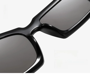 Détail des plaquettes de nez intégrées sur des lunettes de soleil noires irrégulières