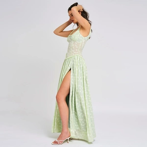 Detailed side view of light green floral maxi dress with sexy high slit and open back design