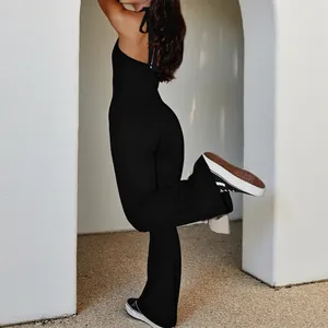 Chic backless halter neck jumpsuit in black featuring slim fit and flared leg design