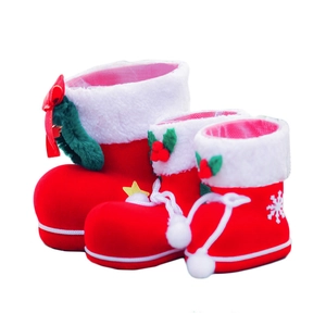 Three sizes of red flocked Christmas boots with white faux fur trim and holly leaf accents