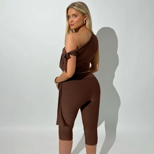 Detail view of the back of a brown one-shoulder top and stretchy cropped leggings set